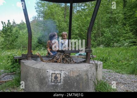 Europa, Germania, Germania meridionale, Baden-Württemberg, regione di Schönbuch, Weil im Schönbuch, due ragazzi si divertono in un barbecue Foto Stock