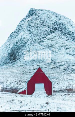 Casa solitaria rossa nel paesaggio innevato in Norvegia, vecchia casa residenziale, casa in legno in zona fiordo Foto Stock