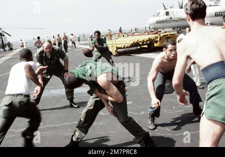 Gli equipaggi a bordo della portaerei USS MIDWAY (CV 41) giocano una partita di calcio sul ponte di volo durante un periodo di attesa. Paese: Oceano Pacifico (POC) Foto Stock