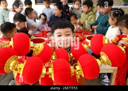 LIANYUNGANG, CINA - 11 GENNAIO 2023 - Un bambino mostra una lanterna in un asilo nido a Lianyungang, nella provincia di Jiangsu della Cina orientale, il 11 gennaio 2023. Foto Stock