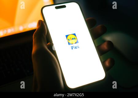 Uomo che utilizza l'app Lidl Plus sullo smartphone. Foto Stock