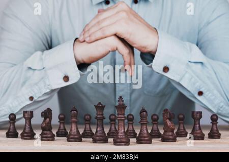 Uomo d'affari con le mani afferrate una strategia di pianificazione di brainstorming nel gioco di successo di concorrenza, strategia di concetto e gestione riuscita o leadershi Foto Stock