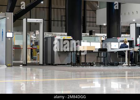 Punto di controllo. controllo alle frontiere. Scansione metal detector di sicurezza AirPort. Svuotare il bagaglio di controllo dello scanner presso il terminale. Rilevamento di gate-ray con cinghia per s Foto Stock