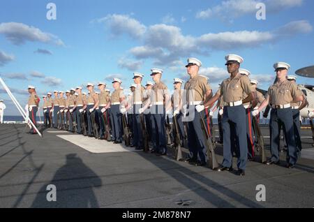 I membri del distaccamento marino della nave stanno in formazione alla parata di riposo mentre la portaerei nucleare USS THEODORE ROOSEVELT (CVN 71) entra nel porto di Nassau, Bahamas. Base: Nassau Nazione: Bahamas (BHS) Foto Stock