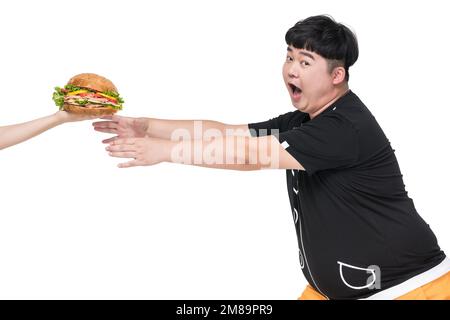 Il giovane obeso cadde sul cibo Foto Stock