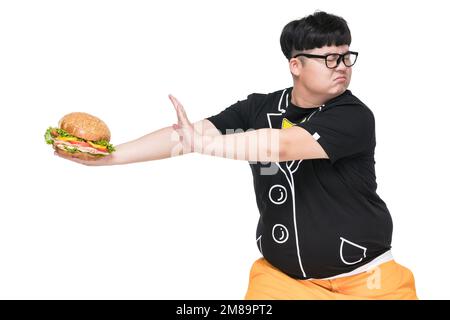 Giovani uomini che trasportano obesità alimentare Foto Stock