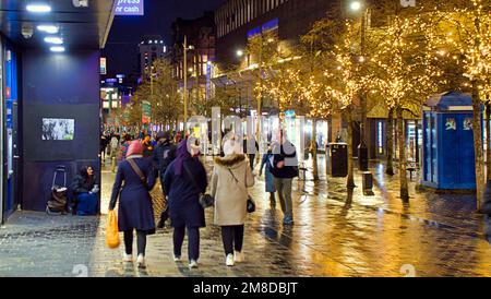 Glasgow, Scozia, Regno Unito 13th gennaio 2023. UK Weather: Recentemente rinnovato e decorato sauchiehall Street con la sua nuova pista ciclabile tutto l'anno luci di tutto l'anno bagnato e ventoso ha visto shopping in tarda notte in sauchiehall Street nel centro della città. Credit Gerard Ferry/Alamy Live News Foto Stock