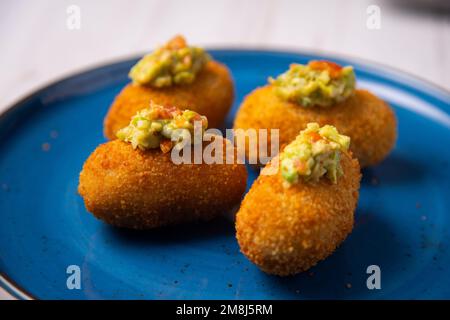 Crocchette di avocado guacamole. Porzione di impasto ottenuta da una salsa densa come il bechamel e una mincemeat di vari ingredienti o verdure. Foto Stock