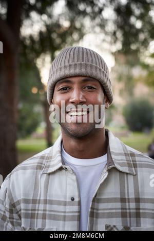 Verticale Ritratto di bel giovane africano sorridente cappello a maglia guardando fotocamera espressione positiva Foto Stock