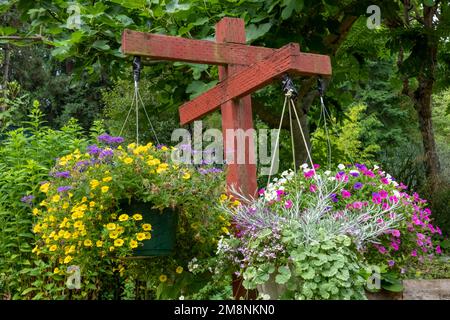 Bellevue, Washington, Stati Uniti. Vasi appesi di fiori tra cui Cabaret di calibrachoa, Petunias e molti altri fiori. Foto Stock