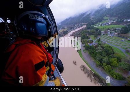 California, Stati Uniti. 11th Jan, 2023. Clayton Maidlow, un tecnico di sopravvivenza dell'aviazione di classe 3rd di stanza alla stazione aerea della Guardia Costiera di Astoria, effettua indagini su una regione allagata del fiume russo durante una missione di sorvolo il 11 gennaio 2023. STATI UNITI Gli equipaggi della Guardia Costiera si sono schierati nella zona della Baia di San francisco da tutta la costa occidentale in risposta alle recenti alluvioni. Credito: USA Coast Guard/ZUMA Press Wire Service/ZUMAPRESS.com/Alamy Notizie dal vivo Foto Stock