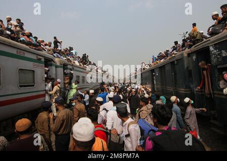 Dhaka, Dhaka, Bangladesh. 15th Jan, 2023. I devoti musulmani viaggiano su treni rischiosi sovraffollati dopo aver assistito all'Akheri Munajat o alle preghiere finali, al Biswa Ijtema di Tongi, Dhaka, Bangladesh. Gli abitanti del luogo affrontano il viaggio salendo, aggrappandosi ai tetti delle locomotive. Senza posti a sedere disponibili all'interno, molti pendolari decidono di correre il rischio e di scegliere una vista sul tetto per il loro viaggio fuori dalla città di Dhaka.milioni di devoti musulmani da tutto il mondo si uniscono all'evento di quattro giorni che culmina nell'Akheri Munajat o nella supplica conclusiva (preghiera finale) in cui mu Foto Stock