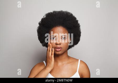 Giovane donna brunetta su ritratto bianco Foto Stock