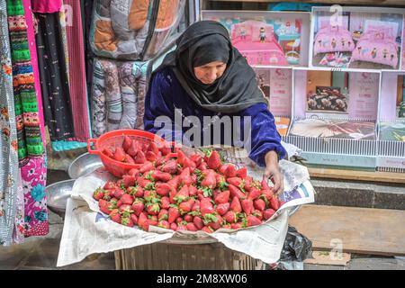 Donna che vende fragole fresche, bazar Khan el-Khalili, Città Vecchia, il Cairo, Egitto Foto Stock
