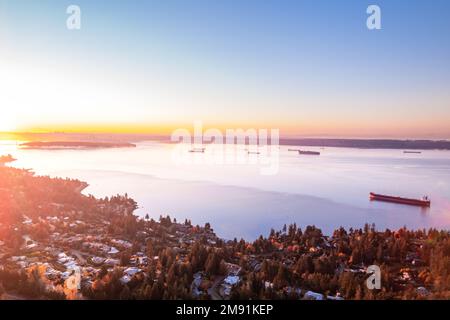 Vista aerea di West Vancouver e Vancouver, paesaggio urbano dell'oceano all'alba, navi da carico, Burrard Inlet, riprese di droni. Foto Stock