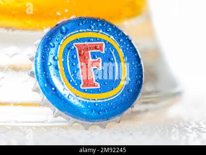 LONDRA, Regno Unito - 15 DICEMBRE 2022: Fosters Australia birra lager tappo bottiglia con rugiada su bianco con vetro. Foto Stock