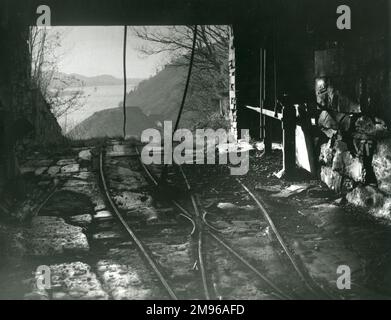 Vista di parte del tram in cima alla Dinorwig (o Dinorwic) Slate Quarry, vicino a Llanberis, Galles del Nord, con trasporto di funi e attrezzature frenanti, e una vista panoramica del paesaggio gallese in lontananza. Foto Stock