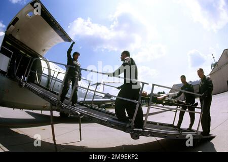 Una squadra di Medevac C-9 Nightingale del 86th° Squadrone Aeromedical e del 75th° Squadrone Airlift, Ramstein Air base, Germania, raccoglie tre soldati americani. Il capitano dell'aeronautica STATUNITENSE Ruth Kawano (a sinistra) dirige un equipaggio di cucciolata sulla rampa del C-9 durante un allenamento. Il Nightingale è l'unico velivolo presente nell'inventario appositamente progettato per spostare i pazienti di cucciolata e ambulatoriali. Questa fotografia è tratta dall'articolo 'No Soldiers of Fortune', AIRMAN Magazine, numero di ottobre 1999. Base: Ramstein Air base Stato: Rheinland-Pfalz Paese: Deutschland / Germania (DEU) Foto Stock