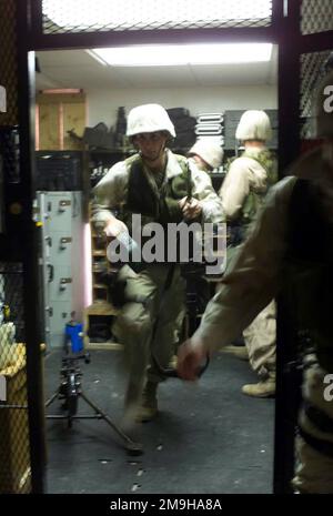 Lance Corporal (LCpl) Paul N. Hagen, USMC, esce dall'armeria dopo aver ricevuto la sua M-249 Squad Automatic Weapon (SAW) durante un esercizio di react drill. LCpl Hagen è un sentry con la compagnia di forze di sicurezza del corpo marino provvisorio, attività di supporto navale, Bahrain. Base: US Naval Support Activity state: Juffair Nazione: Bahrain (BHR) Scene Major Command mostrato: Interim Marine Security Forces Foto Stock