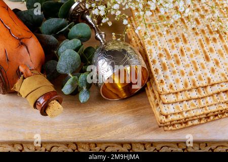 La matzah di pane azzimo è tradizionalmente usata per la festa ebraica di Pesach in combinazione con il vino kosher di tazza di kosher kiddush. Foto Stock