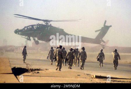 Soldati dell'esercito DEGLI STATI UNITI (USA) assegnati a 2nd battaglione, 3rd reggimento dell'aviazione, si preparano a riarmare un elicottero americano AH-64 Apache, mentre l'aereo atterra dopo una missione volata per distruggere numerose minacce superficie-aria situate a Baghdad, in Iraq, durante l'operazione DI LIBERTÀ IRACHENA. Soggetto operativo/Serie: BASE PER LA LIBERTÀ IRACHENA: Baghdad Paese: Iraq (IRQ) Foto Stock