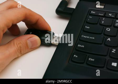 persona che collega l'unità usb alla porta del computer portatile Foto Stock