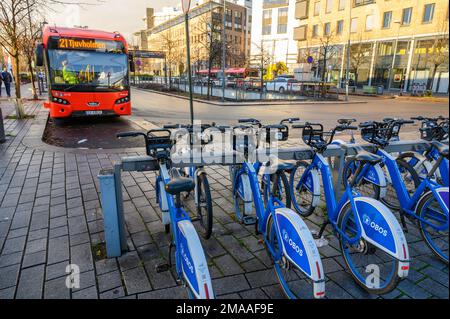 Le bici della città sono parcheggiate in fila con un autobus che si ferma alla stazione finale di Tjuvholmen, Aker Brygge, Oslo, Norvegia. Foto Stock