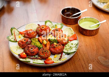 Funghi fritti con salsa di menta e pomodoro e verdure. Foto Stock
