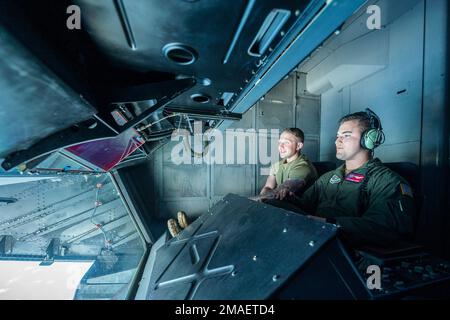 Il Sgt. Barrett Blunt, a destra, operatore del braccio del 9th Air Refueling Squadron, mostra Tech. Tenente Justin Lynch 660th Aircraft Maintenance Squadron Instrument and flight control system sottufficiale in comando, How to Maneuver a boom during a refueling over the Pacific Ocean, 26 maggio 2022. I membri dell'equipaggio hanno eseguito una missione integrata come parte di un addestramento per migliorare le capacità di rifornimento e aumentare la mobilità globale. Foto Stock