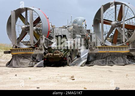 060817-N-1467R-038. [Complete] Scene Caption: 060817-N-1467R-038 (17 agosto 2006)US Marine Corps (USMC) M1116 Up-blindato High-Mobility Multipurpose Wheel Vehicle (HMMWV) guida da Onslow Beach, Marine Corps base (MCB) Camp Lejeune, N.C., a bordo di un Landing Craft Air-Cushion (LCAC), dalla US Navy (USN, ACU) 4, 4). Ci dirigiamo verso la nave da assalto anfibio USN Wasp Class USS BATAAN (LHD 5). Il BATAAN sta conducendo una Expeditionary Strike Group Integration (ESGINT) con la USN Austin Class Amphibious Transport Dock USS SHREVEPORT (LPD 12), USN Harpers Foto Stock