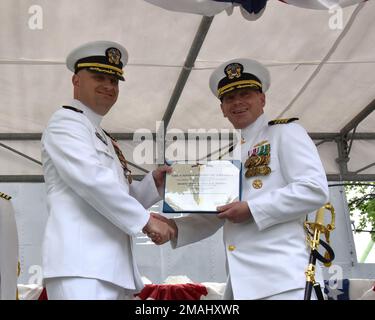 KITTERY, IO. 27 maggio 2022, Portsmouth Naval Shipyard: USS Texas (SSN 775) cerimonia del cambiamento di comando si è tenuta presso il cantiere dove si è svolta la CMdR. Kenneth Cooke è stato sollevato dal CMdR. K. Chad inginella come comandante ufficiale, Texas. Henry Roenke, vice comandante, sottomarino Squadrone DUE (a destra), presenta la Meritorious Service Medal al CMdR. Kenneth Cooke, comandante ufficiale, Texas. Foto Stock