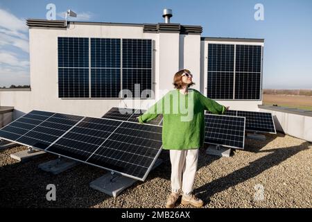 Felice proprietario di una casa con un impianto solare Foto Stock