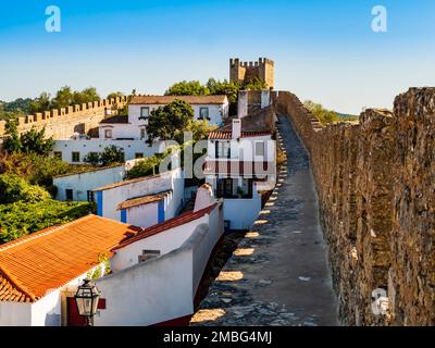 Splendide mura medievali che circondano le case imbiancate del villaggio di Obidos, regione di Oeste, Portogallo Foto Stock