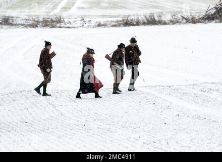 Gammelsdorf, Germania. 21st Jan, 2023. I cannonieri di Boeller camminano attraverso un campo coperto di neve. Diverse centinaia di partecipanti sono venuti alla riunione invernale del patriota dell'Associazione di Königstreuen in Baviera per commemorare la Battaglia di Gammelsdorf nel 1313, considerata l'ultima grande battaglia di cavalieri. Secondo le proprie informazioni, il Verband der Königstreuen e.V. serve a mantenere i costumi bavaresi, la lingua bavarese e la storia, nonché a ricercare il significato della Baviera al tempo dei re bavaresi. Credit: Stefan Puchner/dpa/Alamy Live News Foto Stock