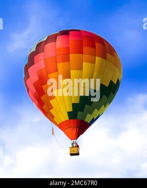 Arcobaleno palloncino ad aria calda su un bel cielo azzurro chiaro e nuvoloso Foto Stock