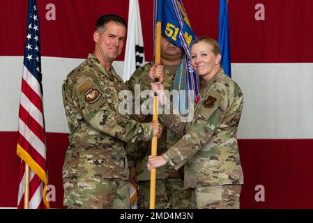 Joshua Wood, 51st Comandante dell'ala combattente, riceve il guidon dal Colonnello Jonelle Eychner, 51st Comandante uscente del gruppo di sostegno della missione, durante la cerimonia di cambio di comando del 51st MSG alla base aerea di Osan, Repubblica di Corea, 13 luglio 2022. Il passaggio della guidon da un comandante uscente a un comandante entrante garantisce che l'unità e i suoi Airmen non siano mai senza leadership. Foto Stock