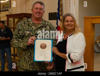 GRANDI LAGHI, il. (15 luglio 2022) Sherri Emerson riceve un premio dal capitano Jason J. Williamson, ufficiale comandante della base navale di Great Lakes, durante un quartier generale. Inaugurato nel 1911, la Naval Station Great Lakes (NSGL) è la più grande installazione di addestramento della Marina e sede dell'unico Boot Camp della Marina. Situato su oltre 1600 acri di terreno affacciato sul Lago Michigan, l'installazione comprende 1.153 edifici di cui 39 nel Registro Nazionale dei luoghi storici. NSGL supporta oltre 50 comandi ed elementi locatari, oltre a 20.000 marinai, marines, soldati e civili DoD che vivono e lavorano sul Th Foto Stock