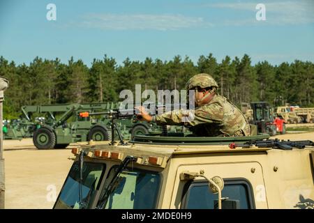 Un soldato della 231st Transportation Company mira alla vista del suo M249 durante la difesa perimetrale alla Independence Tactical Training base il 22 luglio 2022 a Fort McCoy, Wisconsin. Questo esercizio fa parte del programma annuale WAREX in cui le unità della Riserva dell'Esercito conducono una formazione congiunta nell'ambito della Divisione formazione 78th. Foto Stock