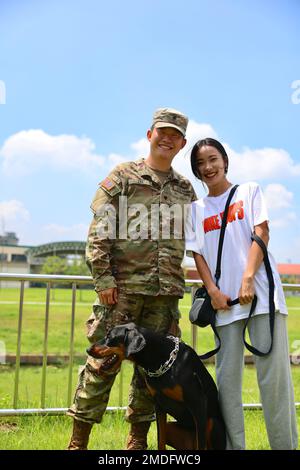 SPC. Namhun Lee prende un momento per posare con la sua moglie e il cane mentre godendo i festeggiamenti messi insieme dal Soldier and Family Readiness Group of Headquarters and Headquarters Company, 2nd Combat Aviation Brigade il 22 luglio 2022. Foto Stock