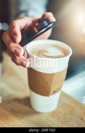 Ora che assomiglia ad una miscela perfetta. Primo piano di un barista irriconoscibile che chiude una tazza di caffè appena fatto in un bar. Foto Stock