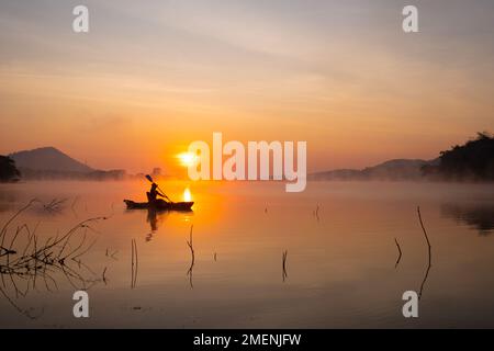 Donne in kayak file nel serbatoio durante l'alba, Harirak parco forestale Huai Nam Man Reservoir Loei Thailandia 21 gennaio 2023 Foto Stock