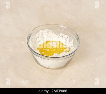 Pane di Naan, fare un pozzo ed aggiungere l'acqua tiepida, lo yogurt ed il ghee fuso Foto Stock