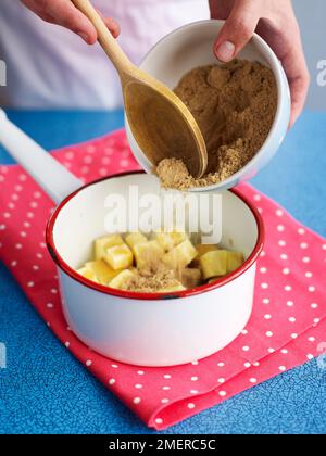 Mettere i cubetti di burro e lo zucchero di canna in una casseruola e preparare i muesli Foto Stock