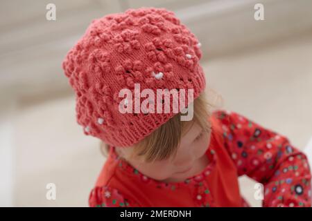 Ragazza che indossa un berretto lavorato a maglia, 3,5 anni Foto Stock