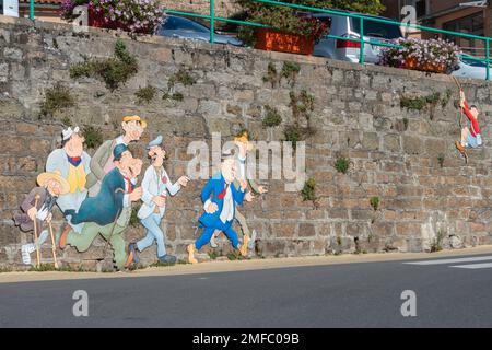 Umoristico muro d'arte su un muro di pietra nel villaggio di Vaux-en-Beaujolais, Francia Foto Stock