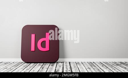 Icona dell'applicazione Adobe InDesign su pavimento in legno contro parete Foto Stock