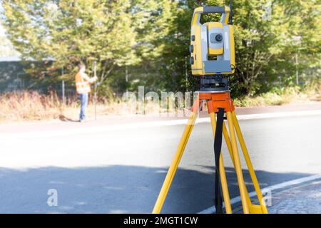 Ingegneri civili in cantiere che utilizzano un altometro Tacheometro per attrezzature Surveyor all'aperto Foto Stock