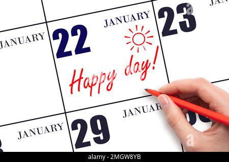 22nd° giorno di gennaio. Scrivere a mano il testo HAPPY DAY e disegnare il sole sulla data del calendario 22 gennaio. Salvare la data. Vacanza. Motivazione. Inverno m Foto Stock