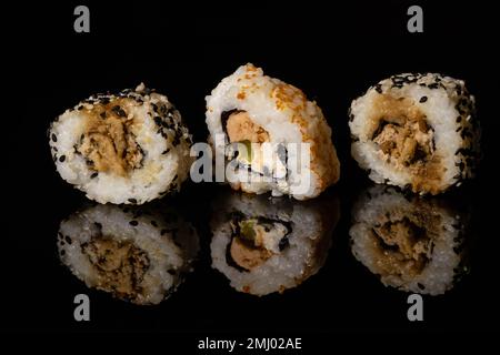 sushi su una superficie riflettente nera Foto Stock