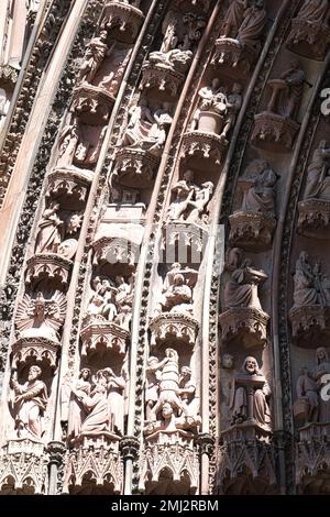 Primo piano di figure in pietra scolpita sul lato superiore sinistro del portale d'ingresso principale sulla facciata ovest della Cattedrale di Strasburgo, Strasburgo, Alsazia, Francia Foto Stock